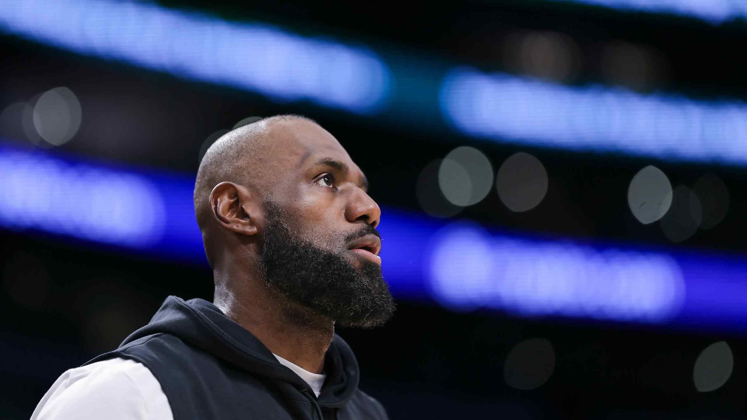 Lebron James in an arena wearing a hoodie.